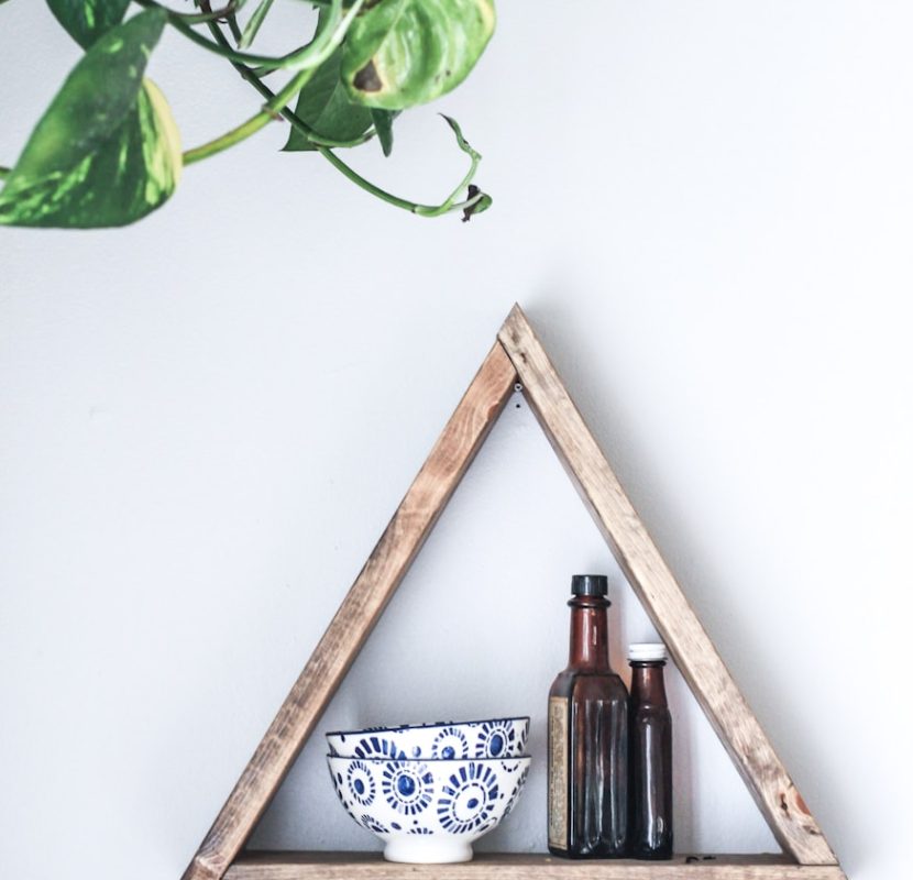 Photo by Kara Eads two white-and-blue ceramic bowls on wooden rack
